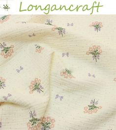 the fabric has flowers on it and is white with pink, purple and green accents