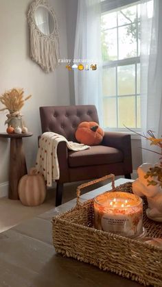 a living room filled with furniture and a basket full of pumpkins on the floor