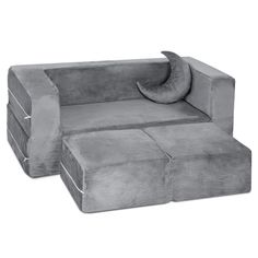 a gray couch sitting on top of a white floor