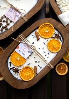 two trays filled with orange slices and spices