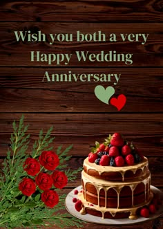 a happy wedding anniversary card with a cake and red roses on the table next to it