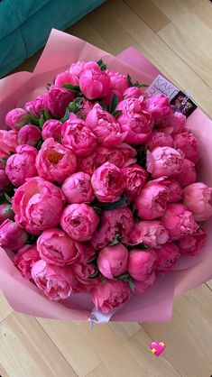 a woman holding a bouquet of pink flowers