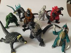 there are many toy godzillas on the table