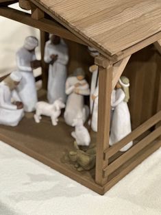 a nativity scene with figurines in a wooden structure