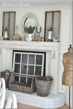 a white fireplace with baskets on the mantel and other items sitting on top of it