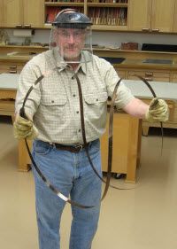 a man wearing a helmet and holding two whips