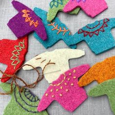 several felt ornaments are laid out on a table