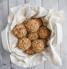 a bowl filled with oatmeal cookies on top of a white cloth