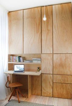 a room with wooden cabinets and a desk