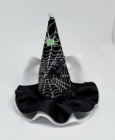 Spider webs miniature witch hat for babies, girls, adults, and pets. Mini hat size is approximately 3.5 inches wide by 4 inches tall. Miniature hat can be attached to a metal alligator clip, a circular Velcro for cranial helmets, a soft elastic headband, or ribbon for pets. Please choose the finish: -3cm Velcro  -2.6 inches metal alligator clip  -5/8 by 16 or 18 inches soft elastic headband  -3/8 by 18 or 25 inches ribbon (for pets) Finish color: -White Velcro  -Metal Clip -Black  -White  -There Cranial Helmet, Mini Witch Hat, Miniature Witch, Mini Hat, Hat Hair, Spider Webs, Elastic Headband, Costume Hats, Elastic Headbands