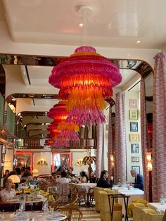 a restaurant with chandeliers hanging from the ceiling