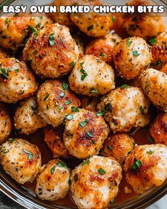 a bowl filled with baked chicken bites covered in seasoning and garnished with parsley