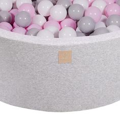 a large gray and pink ball pit filled with balls