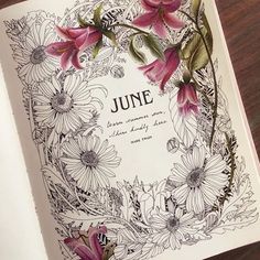 an open book with some flowers on it and the words june written in black ink