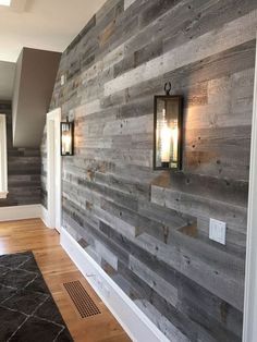 a wood paneled wall with two lights on it