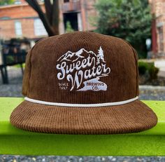 Wanna rep your favorite craft brewery in style? Look no further! This hat will keep the sun out of your eyes, and everyone else's eyes on you! Details: Shape: Flatbill Fabric: 100% Polyester Adjustable Snapback: One Size Fits Most Playful Snapback Hat For Outdoors, Playful Outdoor Snapback Hat, Retro Outdoor Snapback Hat, Brown Snapback Hat For Camping, Camping Snapback Hat, Granola Style, Craft Brewery, Bar Accessories, Hats For Men