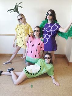 four women dressed in costumes posing for the camera