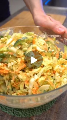 a person is adding coleslaw to a bowl