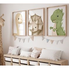 three framed pictures hang on the wall above a wooden bench with pillows and decorative items