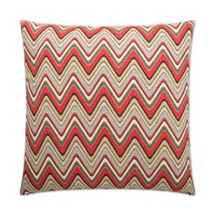 a red and beige pillow with wavy lines on it