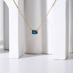 - 14k gold - Center stone: Baguette Cut 6 x 4 mm Blue Topaz (London) - 18" to 17" Adjustable Please note: If you require a different length chain email us at hello@midafinejewelry.com to inquire. Thank you! Luxury Baguette Cut Topaz Jewelry, Elegant Sapphire Necklace With Emerald Cut, Blue Baguette Cut Fine Jewelry, Blue Rectangular Birthstone Necklace, Blue 14k Gold Baguette-cut Jewelry, Blue 14k Gold Jewelry With Baguette Cut, Blue 14k Gold Baguette Cut Jewelry, Emerald Cut Sapphire Gemstone Necklace, Blue Baguette Cut 14k Gold Jewelry