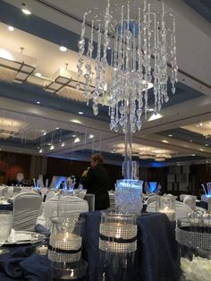 a chandelier hanging from the ceiling in a banquet hall