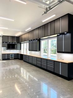 an empty kitchen with black cabinets and white counter tops is seen in this image from the inside