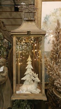 a small christmas tree in a glass case