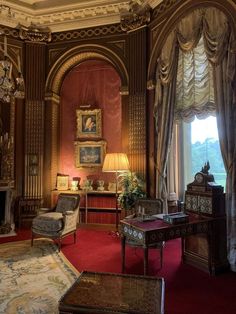 a living room filled with furniture and a fire place in the middle of it's walls