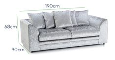 a couch with pillows and measurements for it