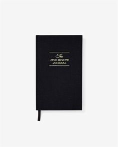 a black notebook with gold lettering on it