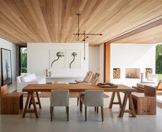 a dining room with wooden ceiling and white walls