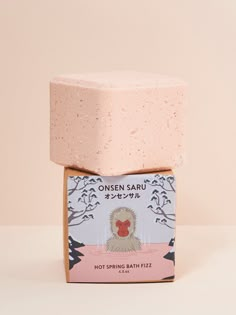 a soap bar sitting on top of a pink box