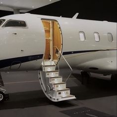 an airplane with stairs going up to the door and landing gear on it's side