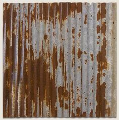 an old rusted metal sheet with white and brown paint