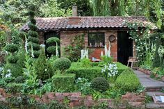 a small house surrounded by greenery and trees