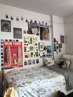 a bedroom with posters on the wall and a bed