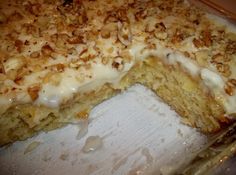 a close up of a cake on a pan with a slice missing from the cake