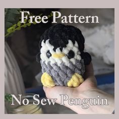 a hand holding a small crocheted penguin