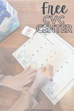 a child's hand writing on a paper with the words free cvc center