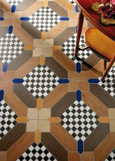 a table and chair in a room with checkered flooring