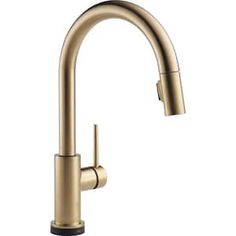 the kitchen faucet is shown in gold