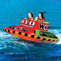 two girls are riding on an inflatable boat