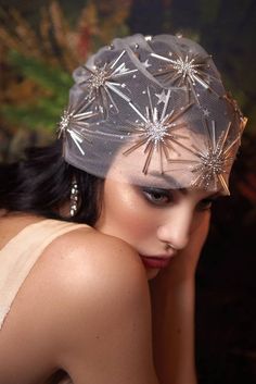 a woman wearing a silver hat with stars on it