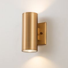 a wall mounted light on the side of a white wall