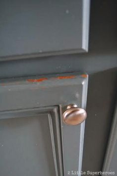 an open door with the handle on it and rusted metal knobs is shown