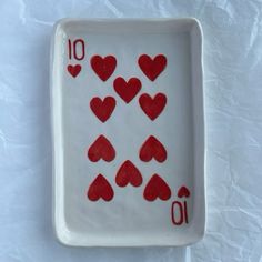 a white plate with red hearts on it