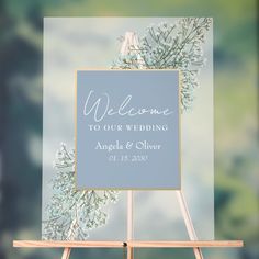 an easel with a welcome sign on it