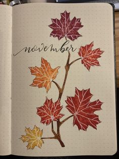 an open notebook with leaves drawn on it and the words november written in cursive writing