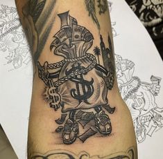 a man's arm with a tattoo on it and an anchor in the middle